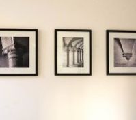 Three black and white framed artworks