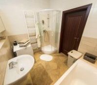 The bathroom has a big stand-alone bath and a separate shower. 