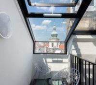 Glass balcony overlooking Prague rooftops