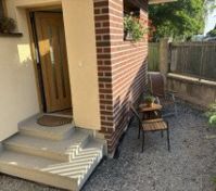 Main entrance door and outside seating.