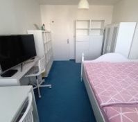 Bedroom with TV desk and shelving