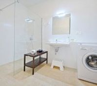 large and modern bathroom + washing machine, shower