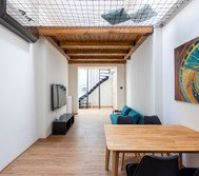 Open living area with wooden beam ceiling