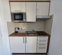 Compact kitchen with microwave and hob