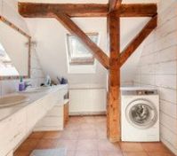 Guests can utilize two sinks and washing machine, there is darkening shade on the window. 