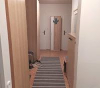 Hallway with wardrobe and striped rug