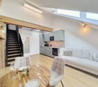 Open kitchen and living area with stairs