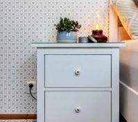 White nightstand beside bed