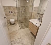 Tiled bathroom with walk-in shower