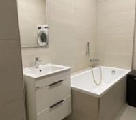 Bathroom with bathtub and washing machine