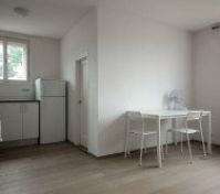 Dining area with kitchen and windows