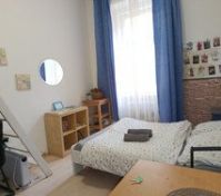 Apartment has a double bed, wardrobe, table, desk with chairs, night table, cabinets, ladder and loft with extra bed