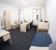 Bright bedroom with desks and sofa