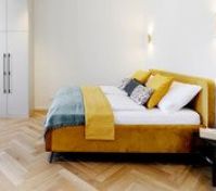 Bright bedroom with yellow velvet bed