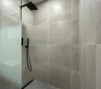 Walk-in shower with black fixtures