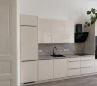 Modern kitchen with glossy cream cabinets