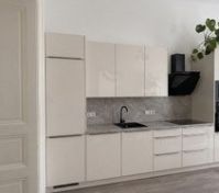 Modern kitchen with glossy cream cabinets