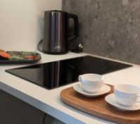 Kitchen cooktop with kettle and cups