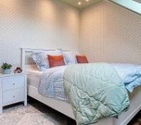 Double bed with white nightstand