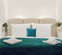 Double bed close-up with teal bedding