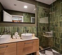 Green tiled bathroom double sinks shower