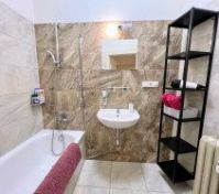 Marble tiled bathroom with tub