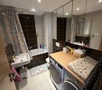 Bathroom with bathtub and washing machine