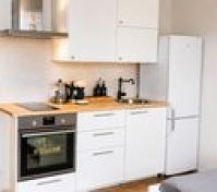 White kitchen with oven and fridge