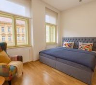 Bright bedroom with double bed and chair