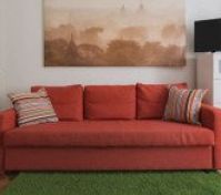 Red sofa with TV and dresser
