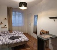 This is how it looks when you walk in to the apartment.  Double bed, table with chairs, mirror, glass table and a single  sofa chair (not shown).  The door on the right leads to the kitchen. 