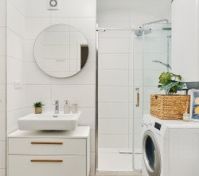 White bathroom with shower and washer