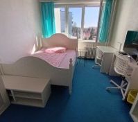 Bright bedroom with desk and TV