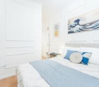 Bright bedroom with wave art