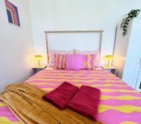 Bed with pillows and lamps