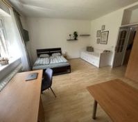 Spacious bedroom with desk and sofa