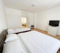 Bright bedroom with beds and TV