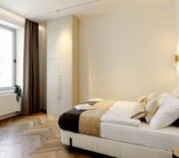 Bright bedroom with wardrobe and TV