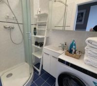 Bathroom with shower and washer