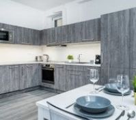 Kitchen with a dishwasher, coffeemaker, washing machine etc.
