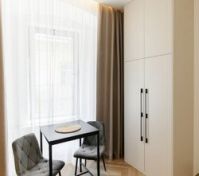 Dining table and wardrobe by window