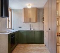 Green kitchen with wood cabinetry