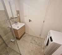 Bathroom with shower and washer