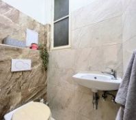Toilet and sink tiled room