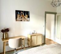 Bedroom with desk and artwork
