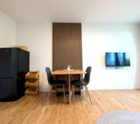 Dining area with TV and fridge