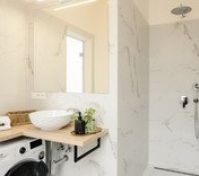 Marble bathroom with shower and washer