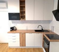 Modern white kitchen with wood countertop