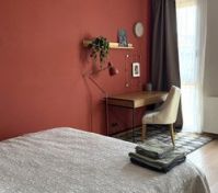 Bedroom with desk red accent wall