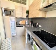 Kitchen with open fridge washer